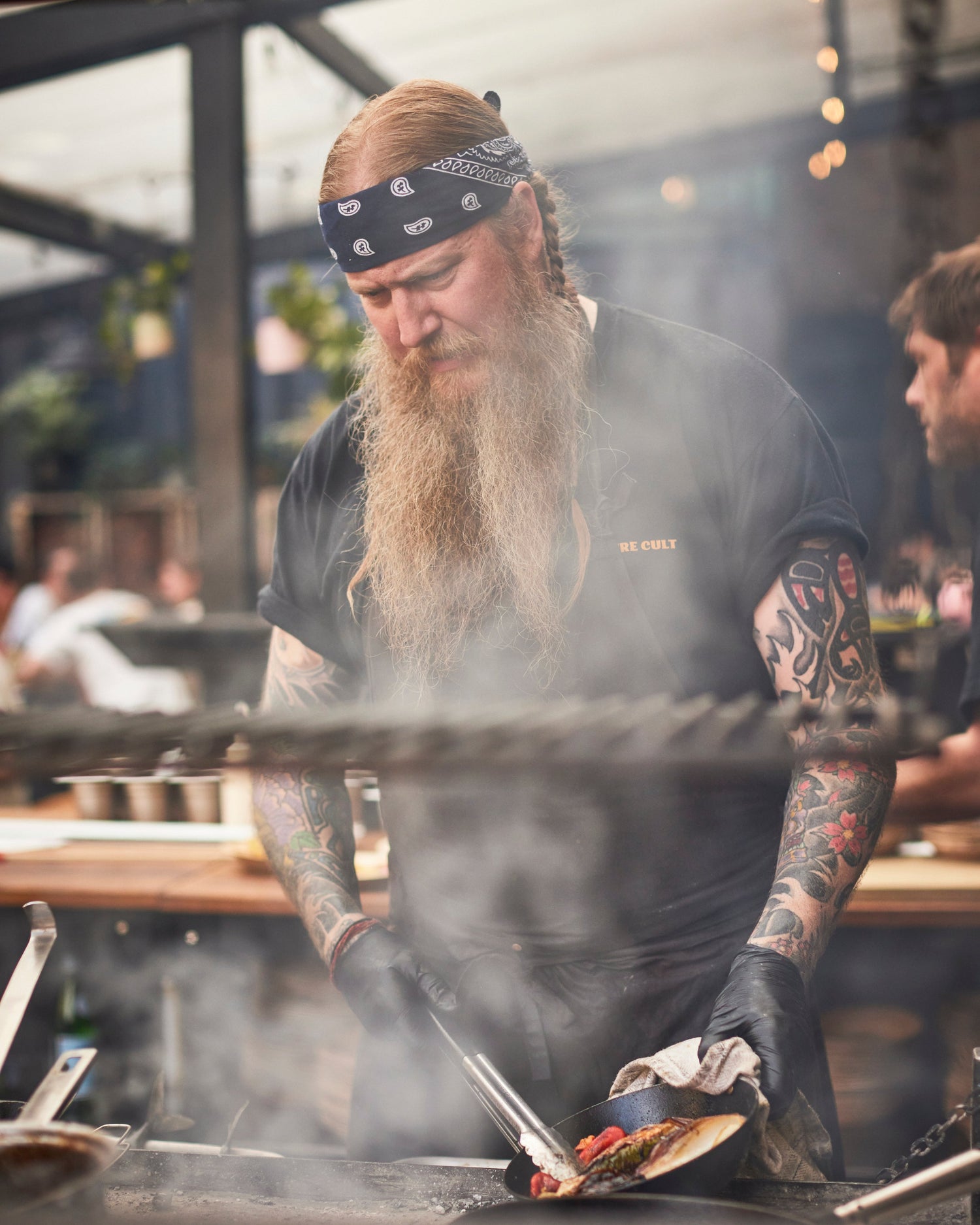 Andrew Clarke founder of Acme Fire Cult Cooking in outdoor live fire kitchen